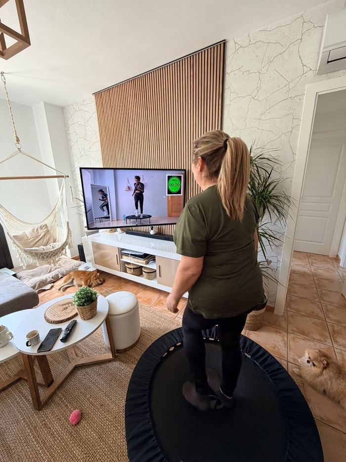 Una alumna entrena en su sala con el mini trampolín